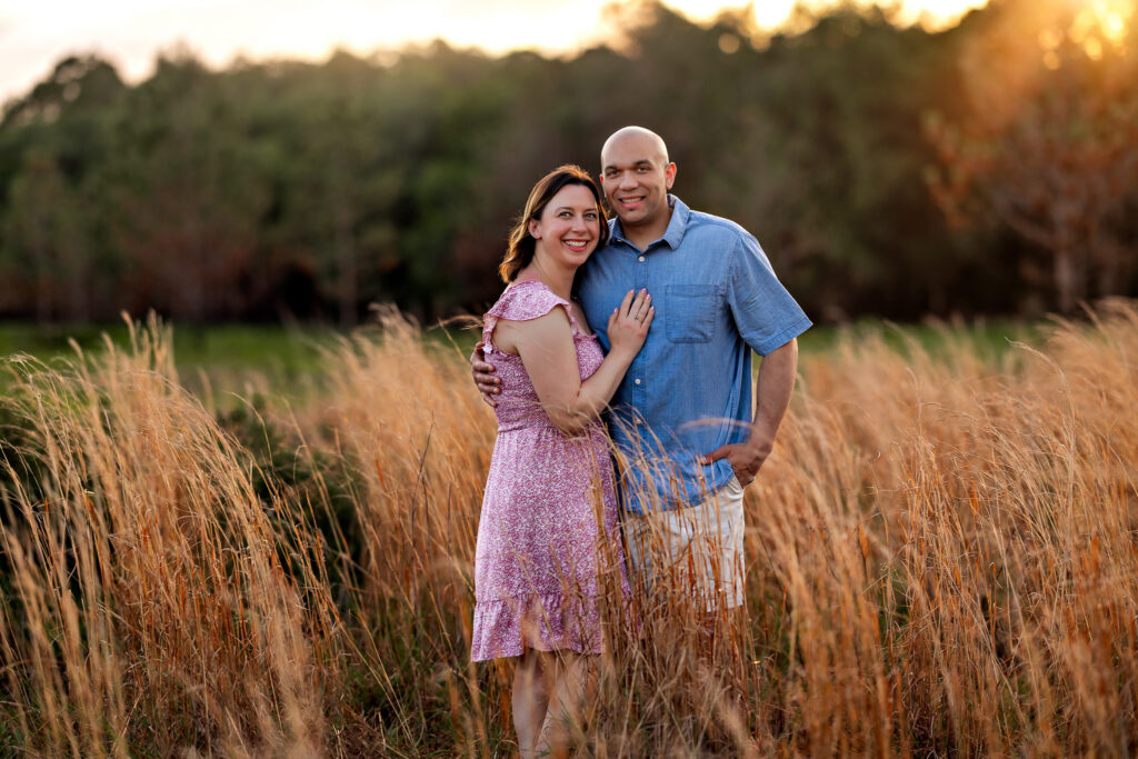 Portrait of the Littles parents with their son at golden hour Lake Louisa State Park Clermont FL family session