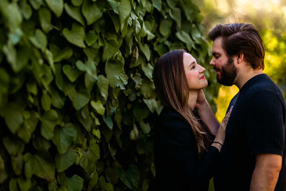 Romantic engagement portrait of Thomas and Emily embracing under oak trees at Leu Gardens Orlando by bold vibrant Orlando Florida photographer