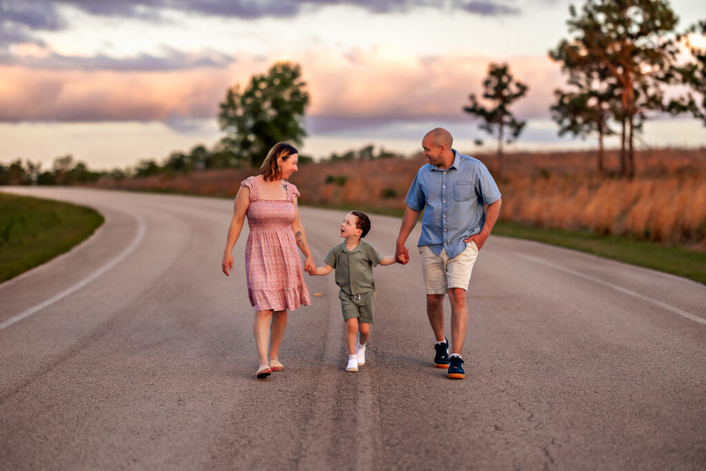 Littles family walking hand-in-hand through oak grove at Lake Louisa State Park near Orlando Florida