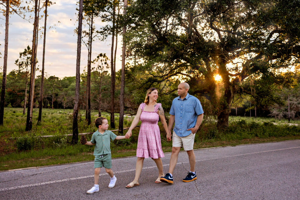 Littles family walking hand-in-hand through oak grove at Lake Louisa State Park near Orlando Florida