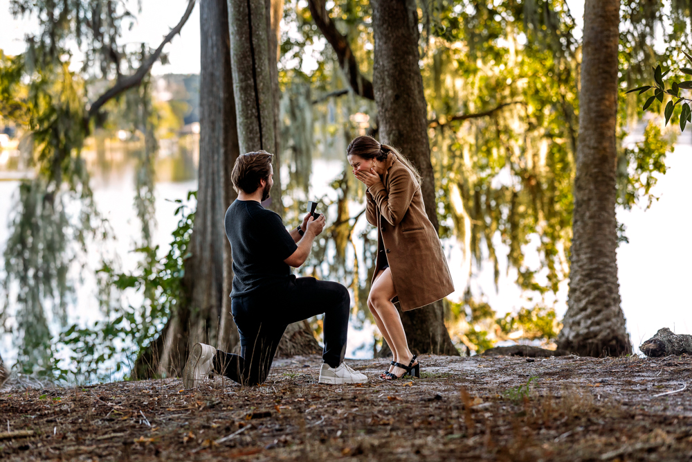 Romantic engagement portrait of Thomas and Emily embracing under oak trees at Leu Gardens Orlando by bold vibrant Orlando Florida photographer