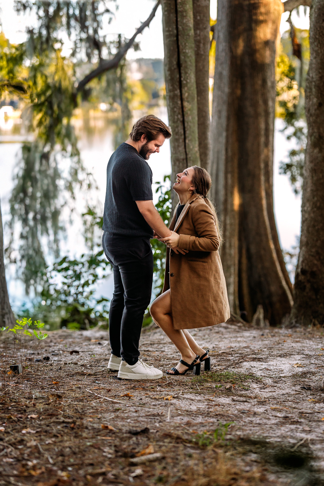 Romantic engagement portrait of Thomas and Emily embracing under oak trees at Leu Gardens Orlando by bold vibrant Orlando Florida photographer