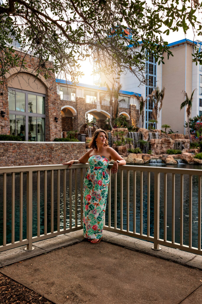 Karli by the iconic blue waterfalls at Loews Sapphire Falls Resort, Universal Orlando – stunning branding photography highlighting resort vibes