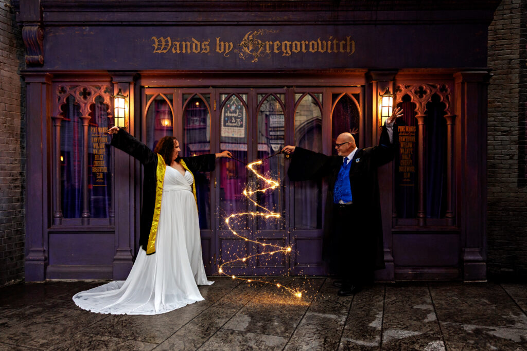 Heidi and Scott in house robes kissing with wands at Wands by Gregorovitch
