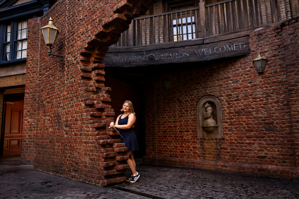Jayda stands inside the entrance of Diagon Alley with no one in the background