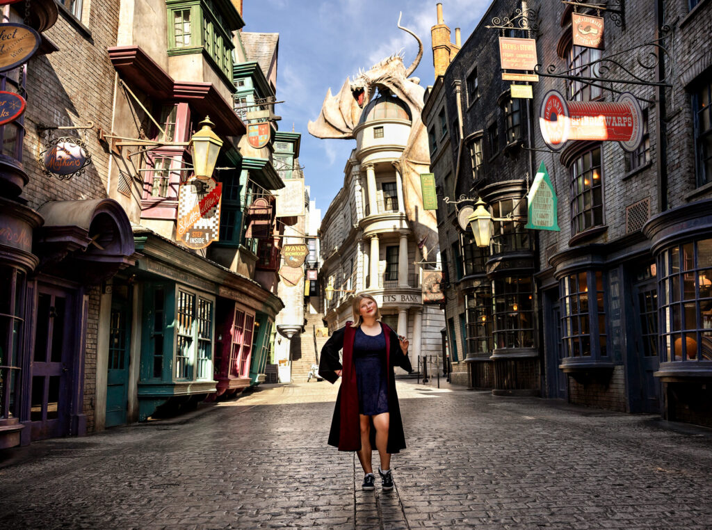 Jayda stands in front of the gringott's dragon