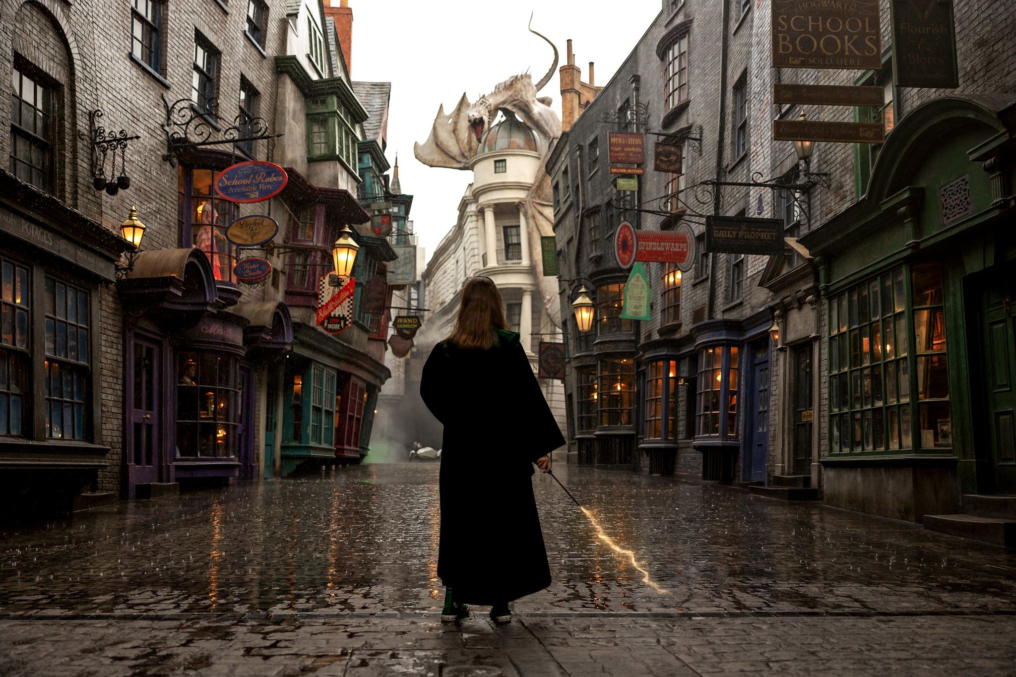Madison walking the cobblestone streets of Diagon Alley during a rainy senior photo session