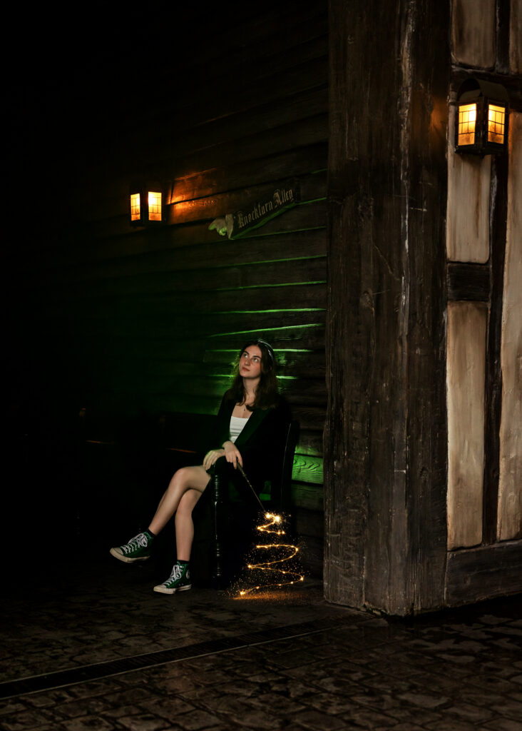 Madison sitting in Knockturn alley, casting a spell