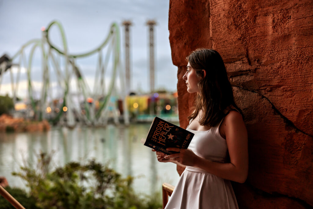 Madison reading her favorite book with a view of Marvel Super Hero Island