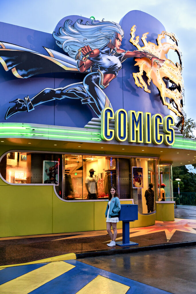 Madison standing in front of the comic store in Marvel Super Hero Island